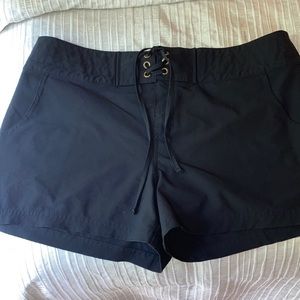 Swim shorts by LaBlanca. Black tie-front. Mid-rise.